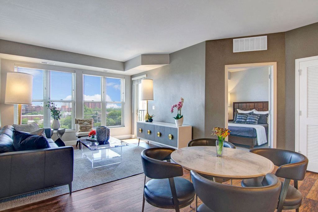 A living room with a dining table and chairs and a couch.