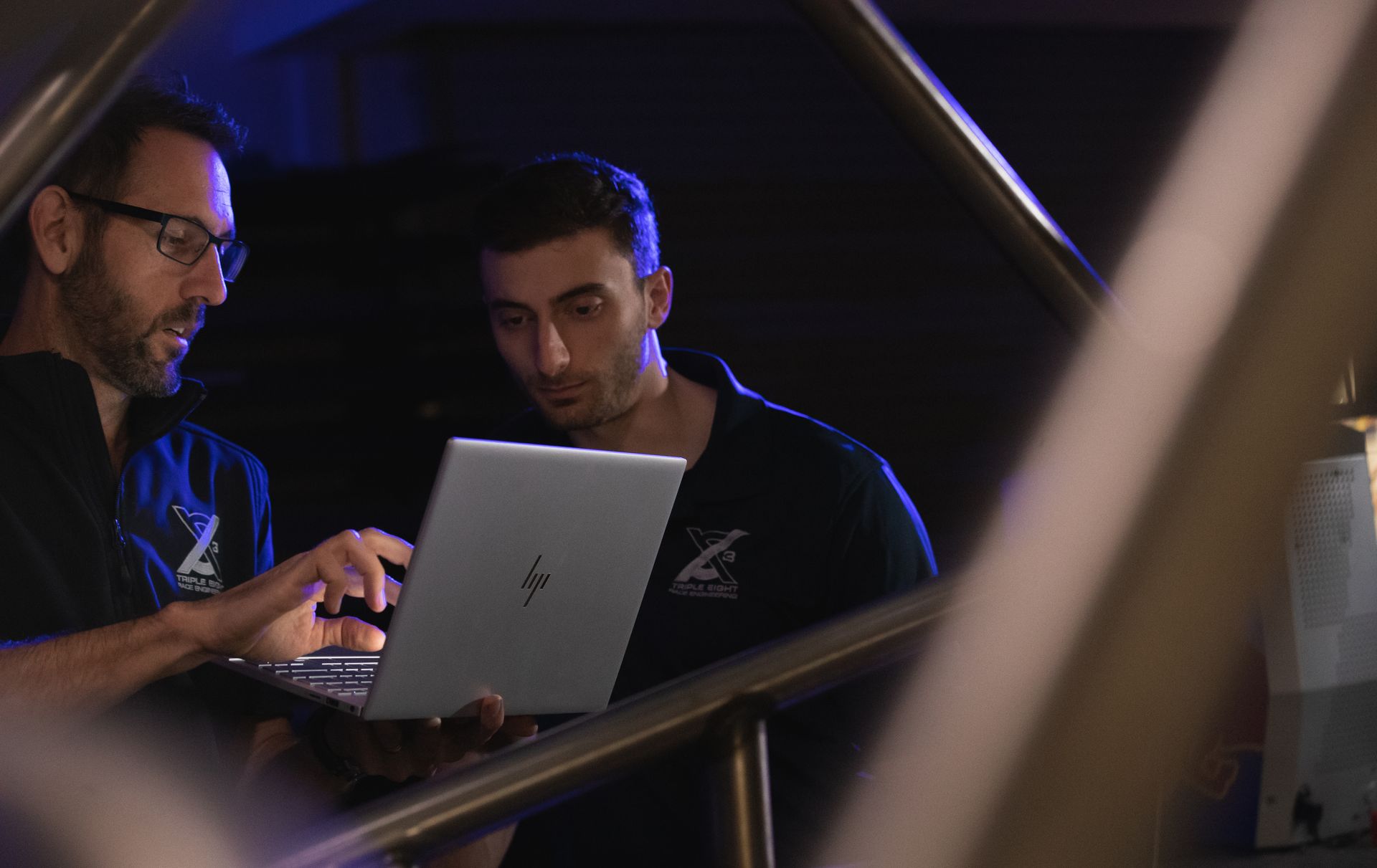 2 people talking about a design on a laptop