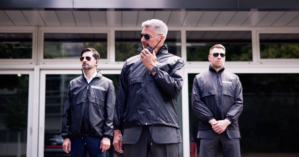 A group of men are standing in front of a building.