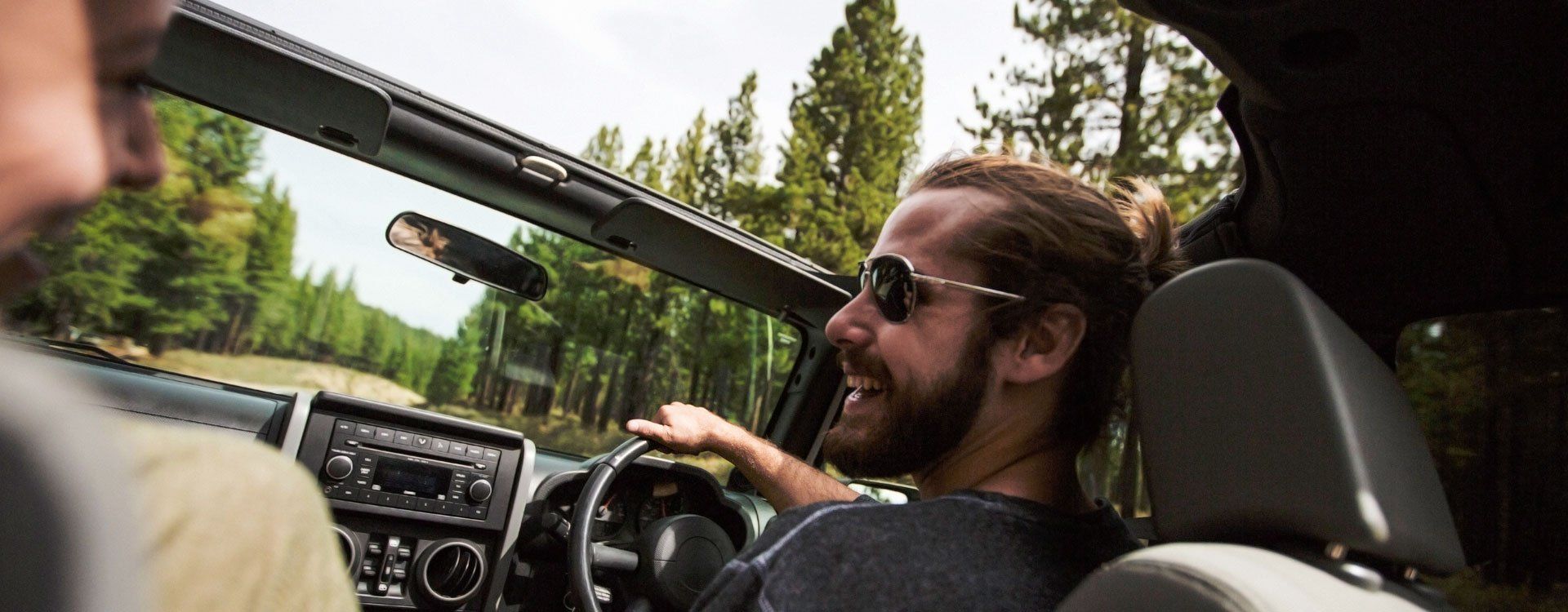 A man with sunglasses driving