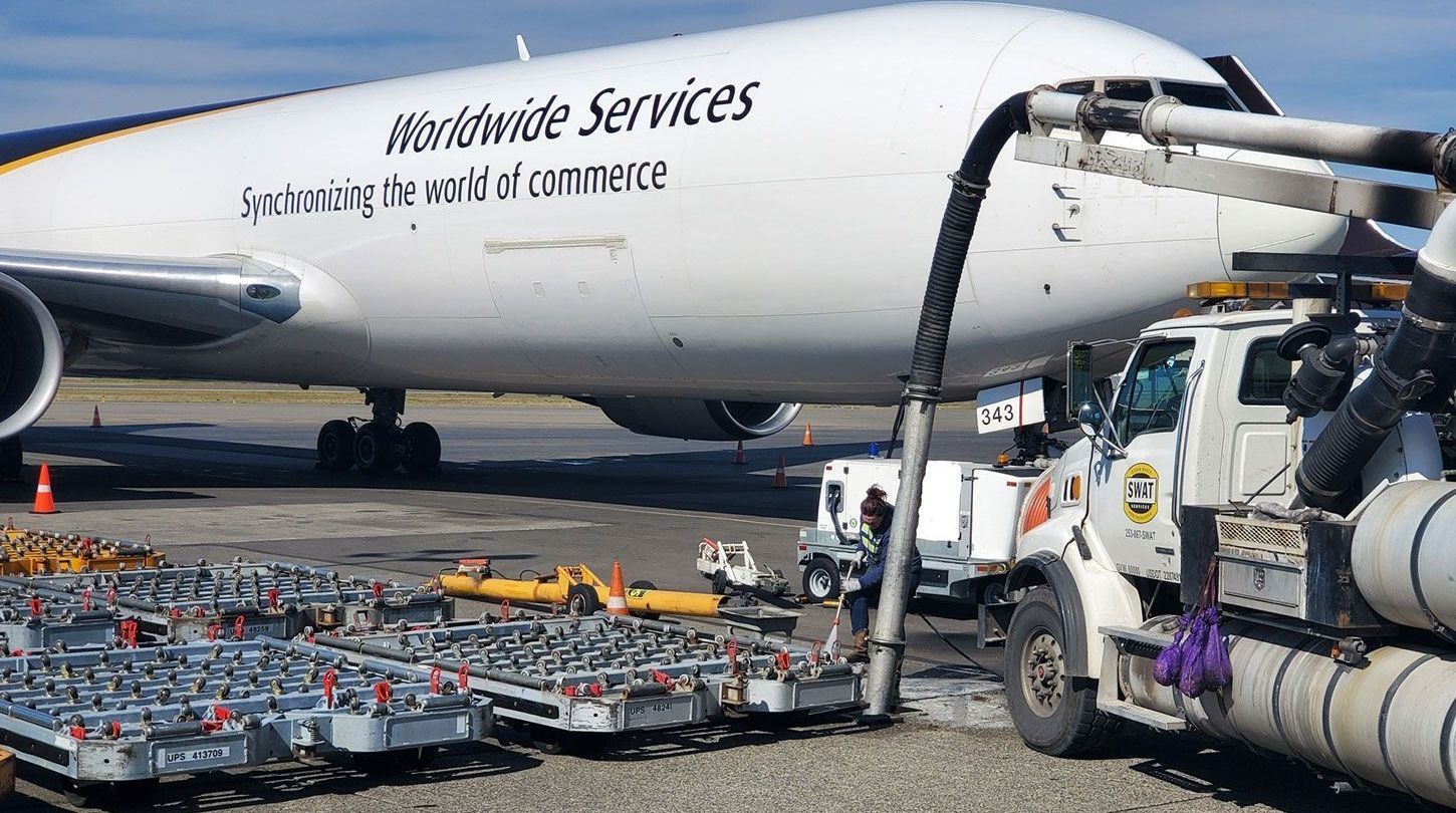 A worldwide services plane is being fueled by a truck