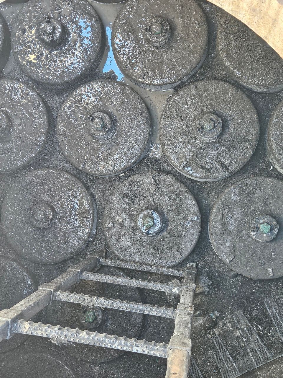 A close up of a circular object with a ladder in the background.