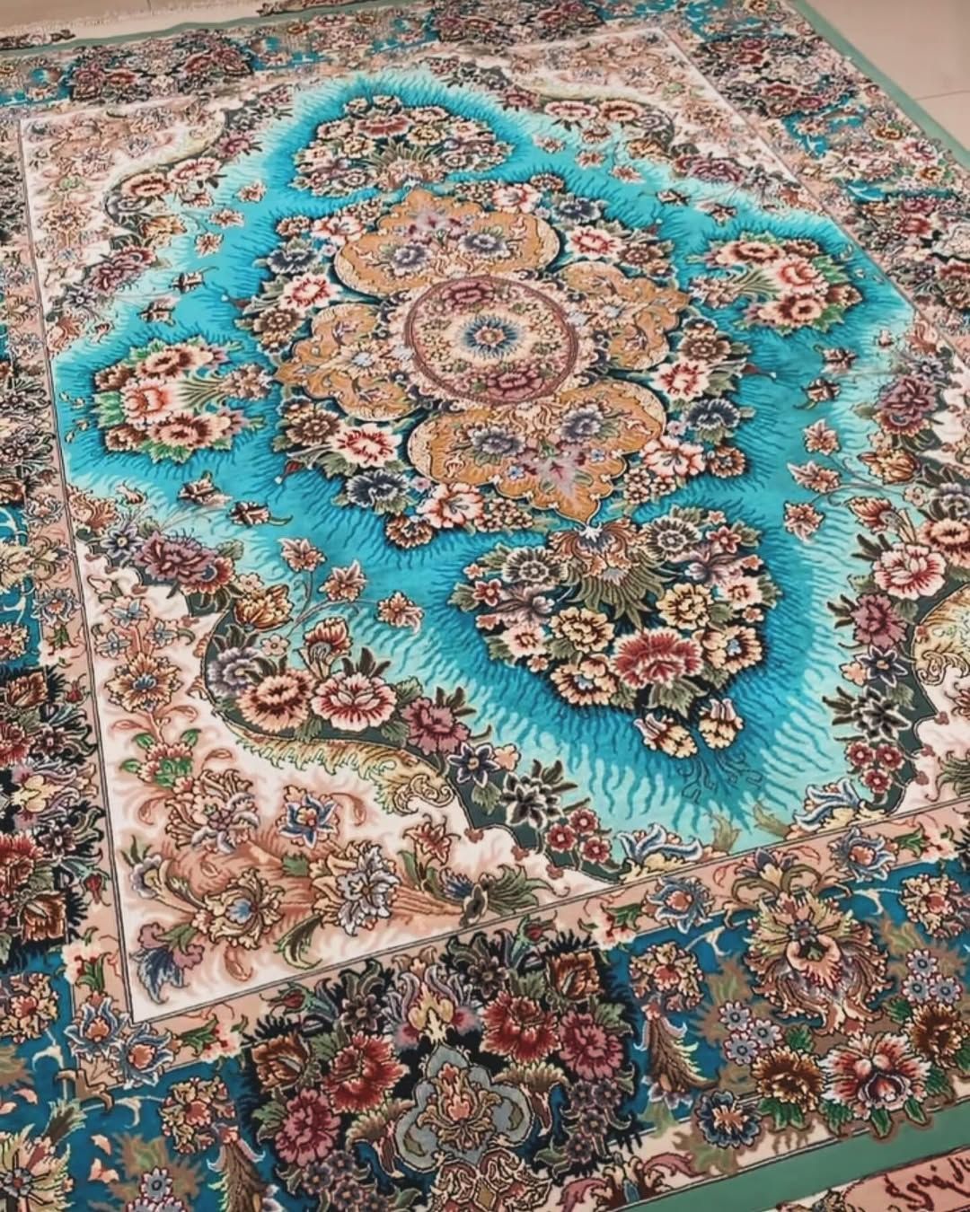 Detailed floral pattern rug with turquoise and gold central design.