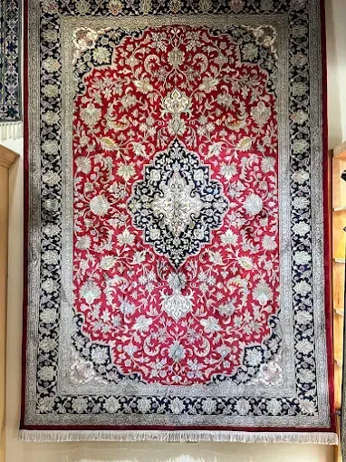 Red and blue patterned Persian rug with floral motifs and border.