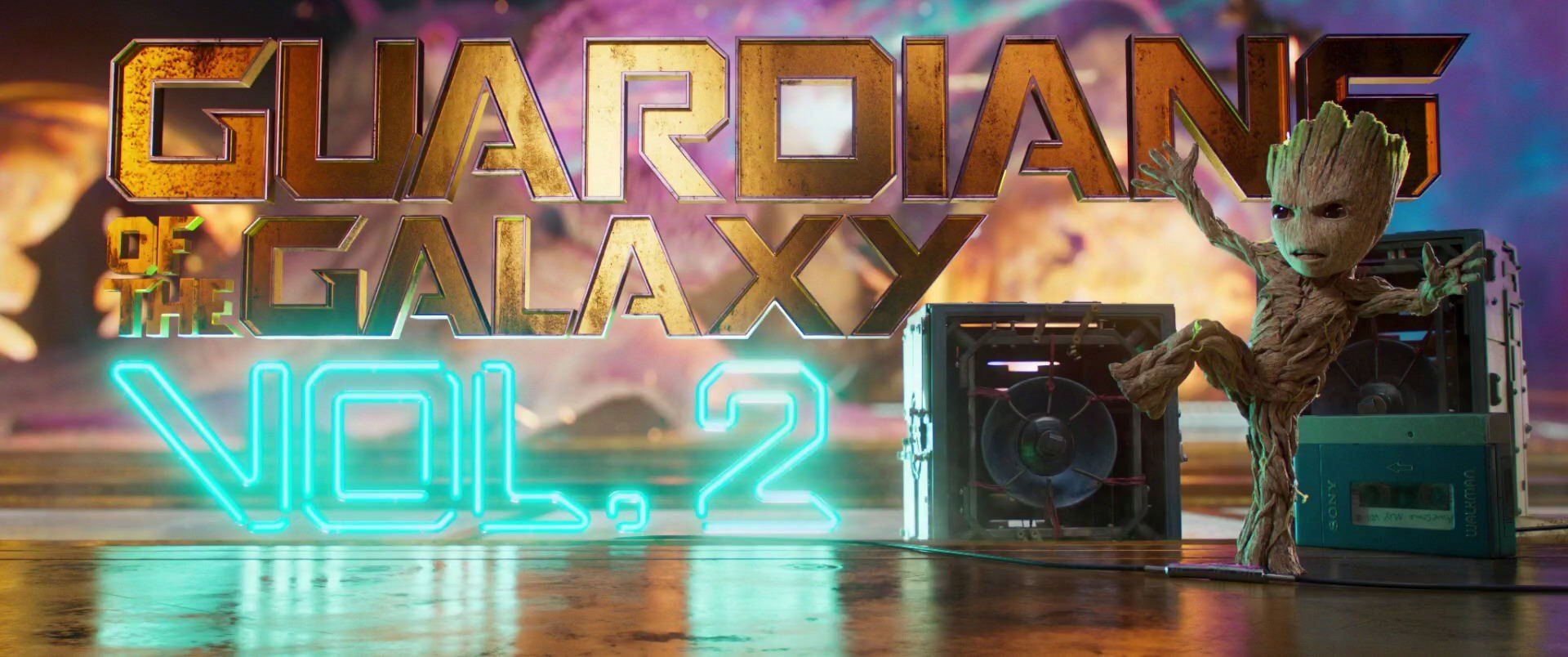 baby groot dancing in front of the guardians of the galaxy 2 logo