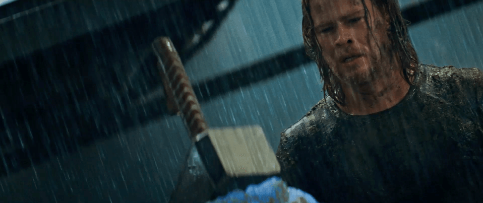 thor staring at his hammer in the rain
