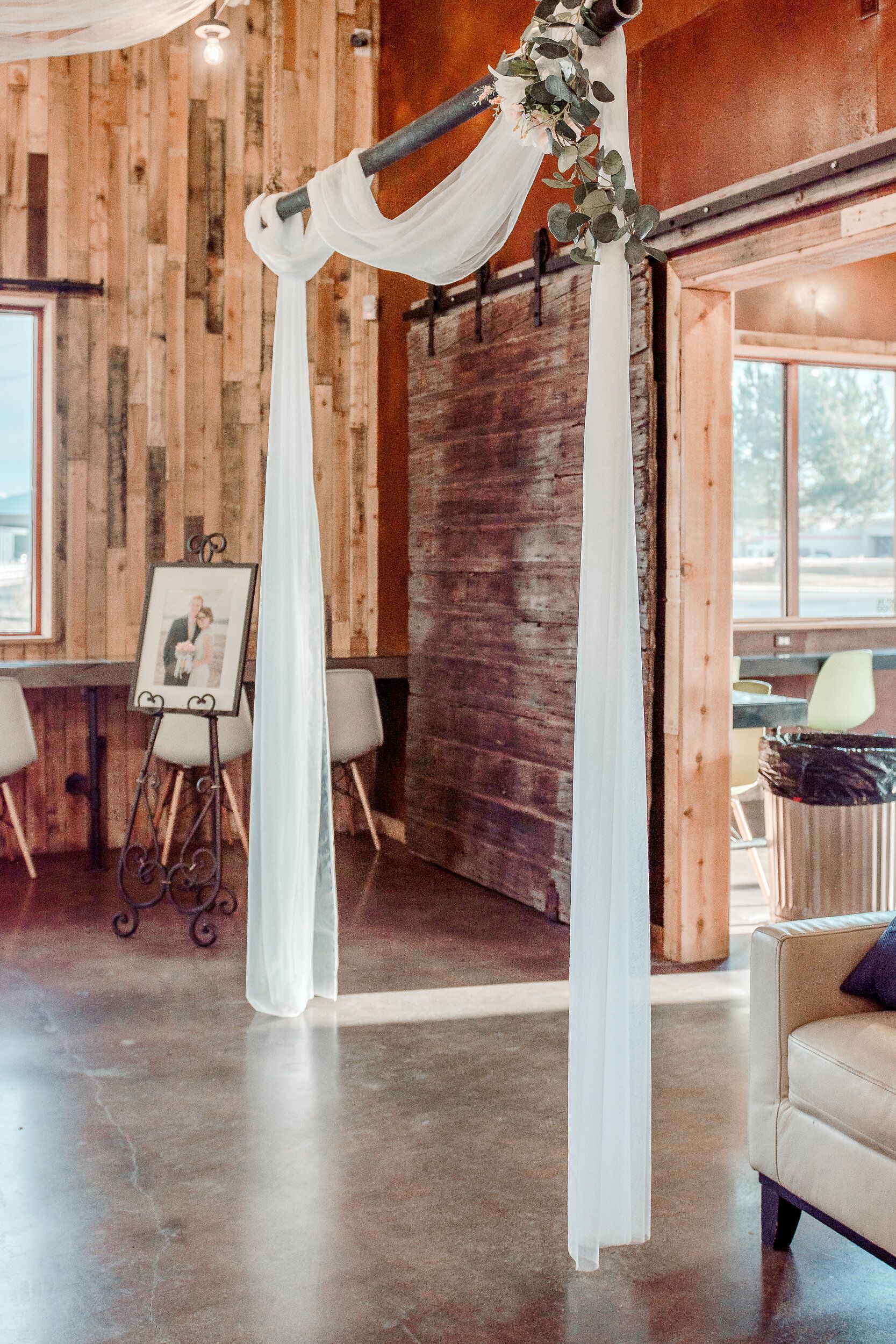 There is a white arch in the middle of the room.