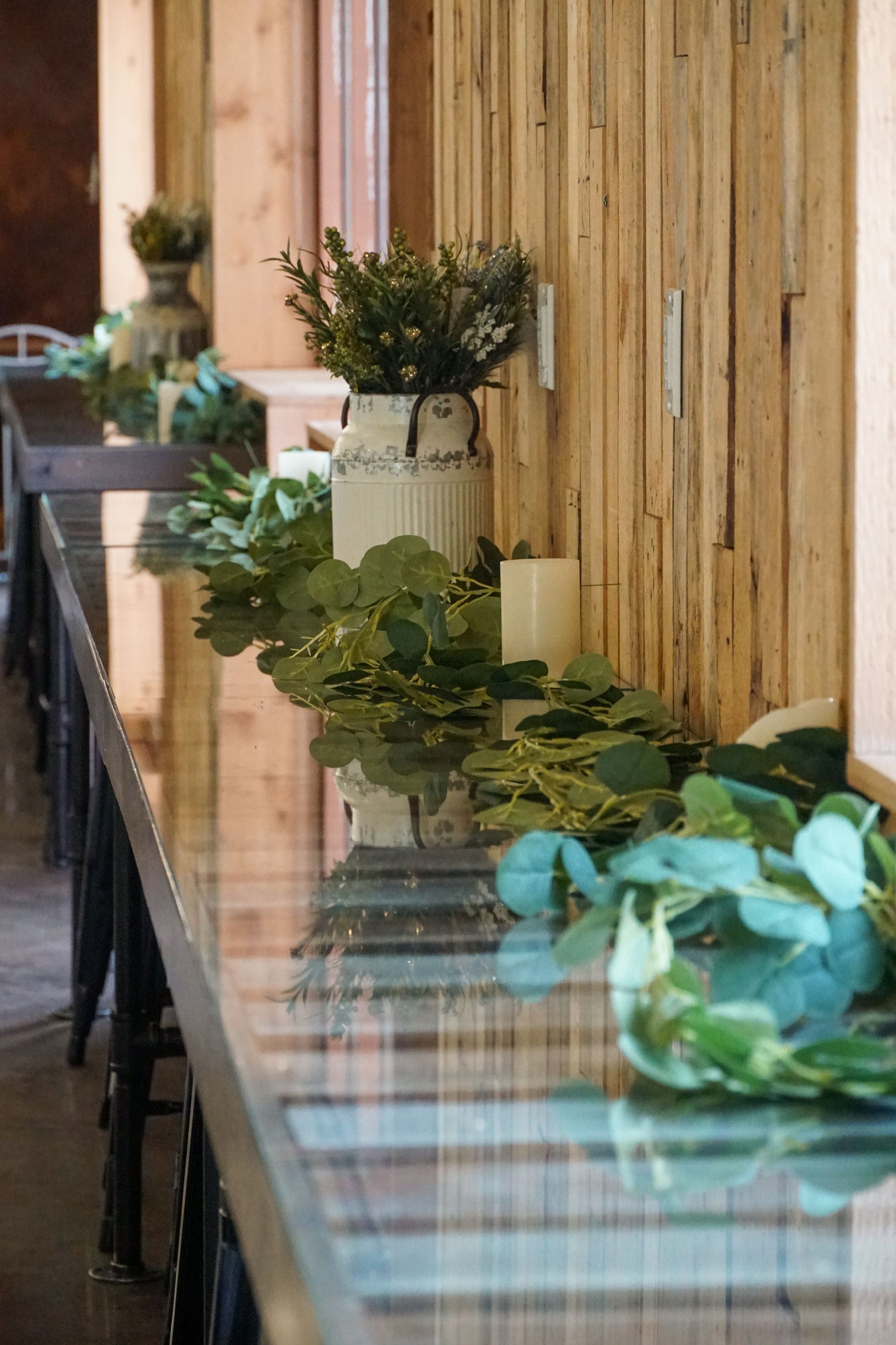 A large room filled with tables and chairs and a projector screen.