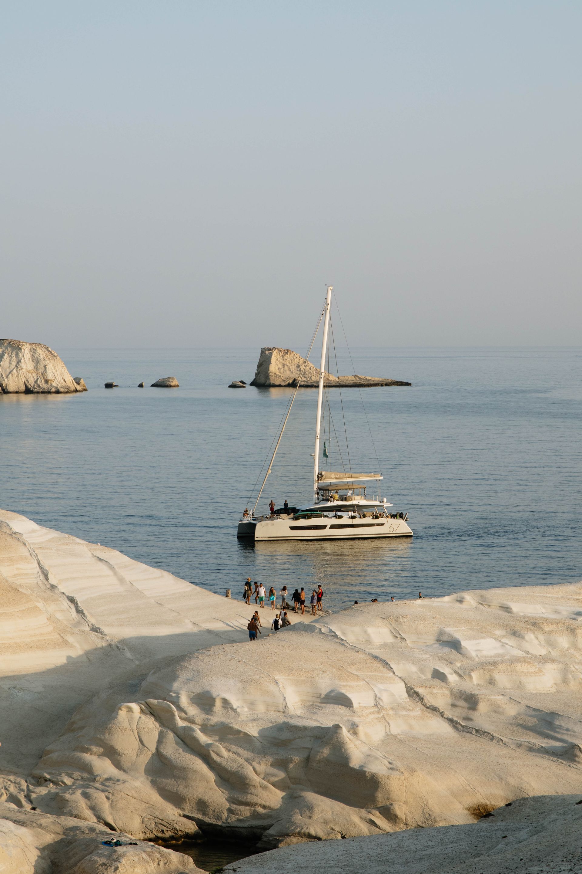 A sailboat is floating on top of a large body of water.