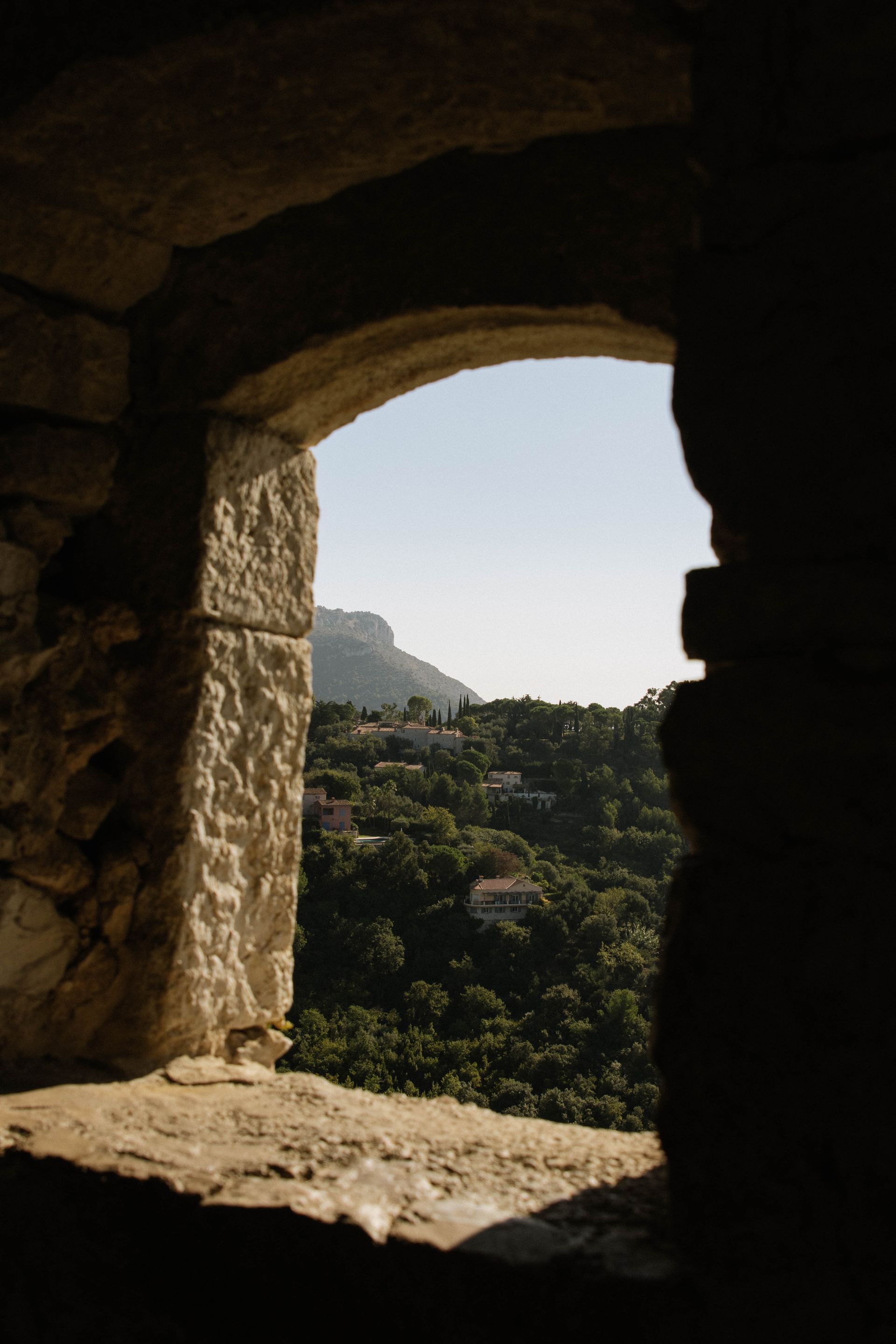 A view of a valley through a stone archway