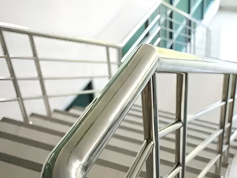 A Close Up Of A Stainless Steel Railing On A Set Of Stairs — Gladstone Sheet Metal Pty Ltd In Gladstone Central, QLD