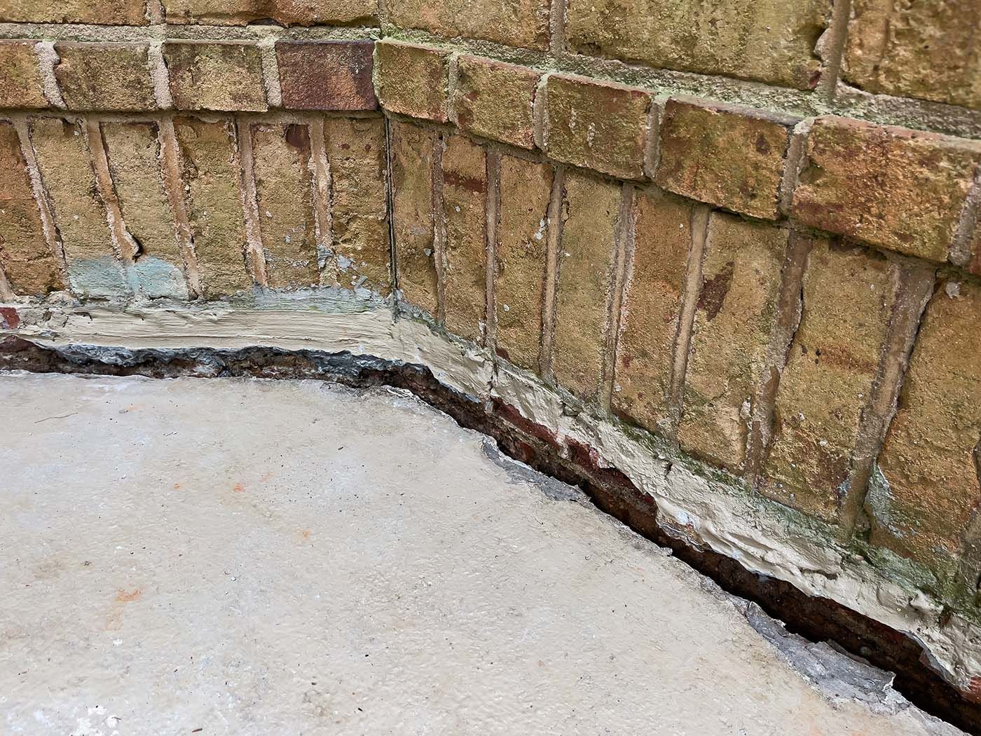 sinking concrete slab near foundation in need of foam concrete leveling. 