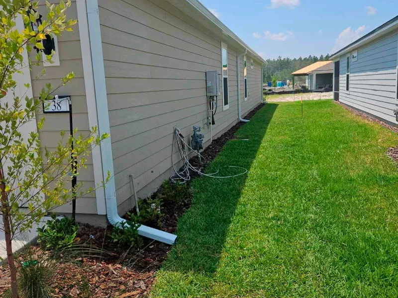 A house with a large lawn in front of it.