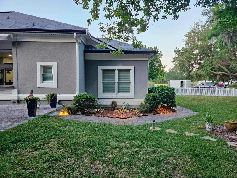 A house with a fire pit in front of it.