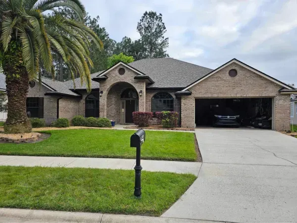 A brick house with a palm tree in front of it