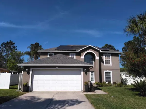 A house with a garage and solar panels on the roof