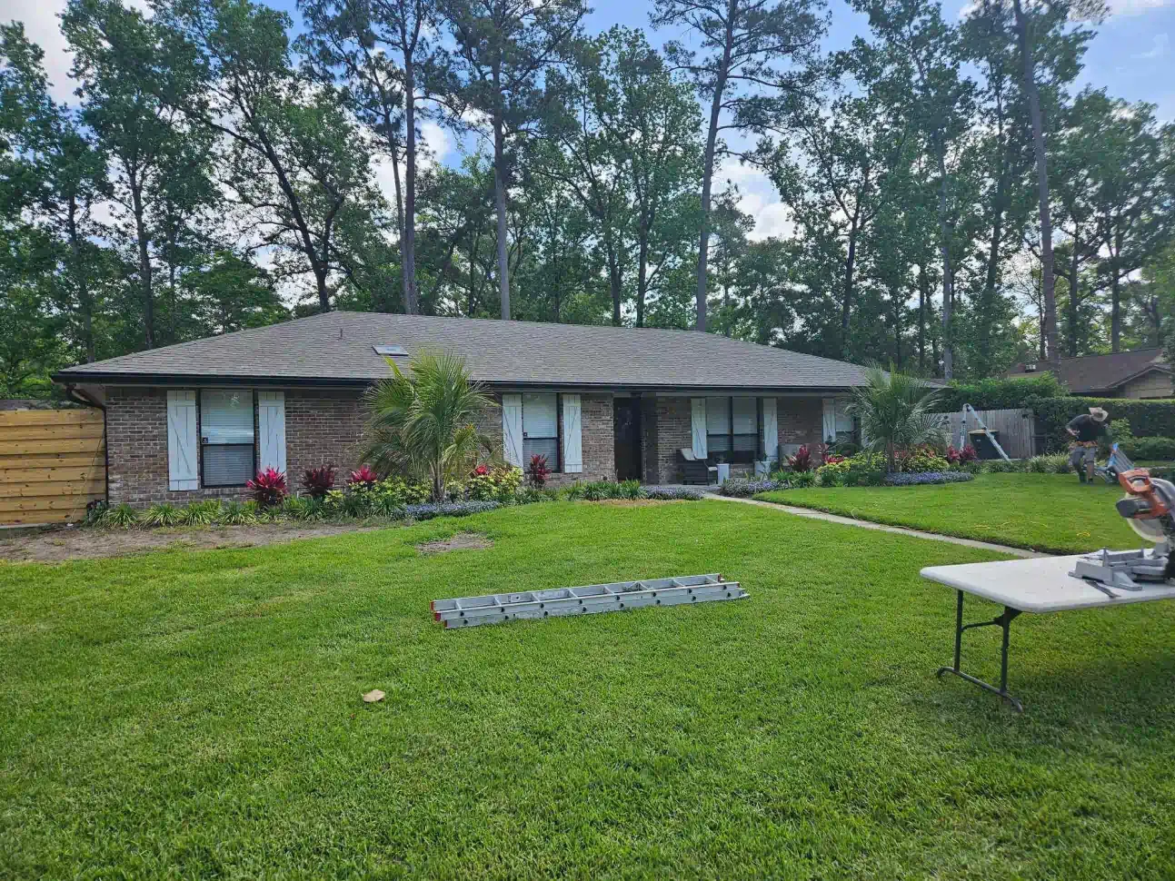 A house with a large lawn and a table in front of it.