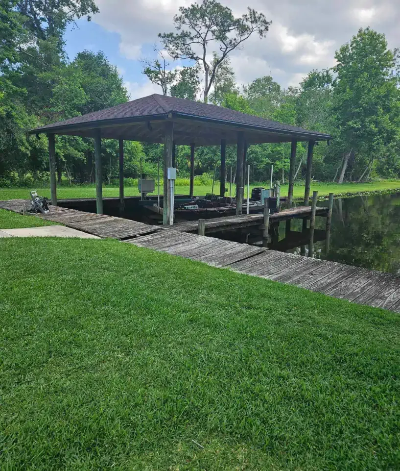 A dock with a pavilion overlooking a body of water.