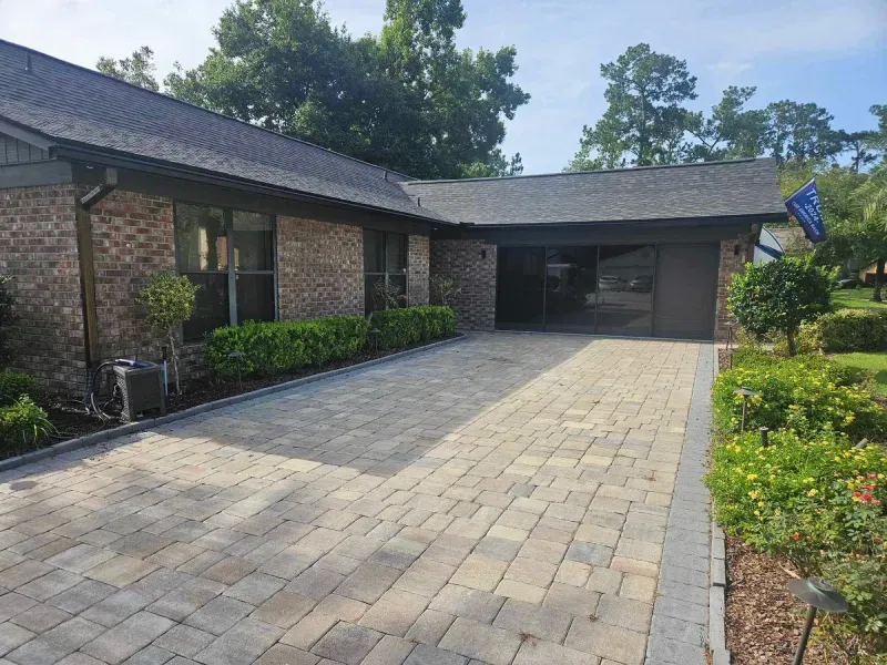 A large brick house with a driveway leading to it.