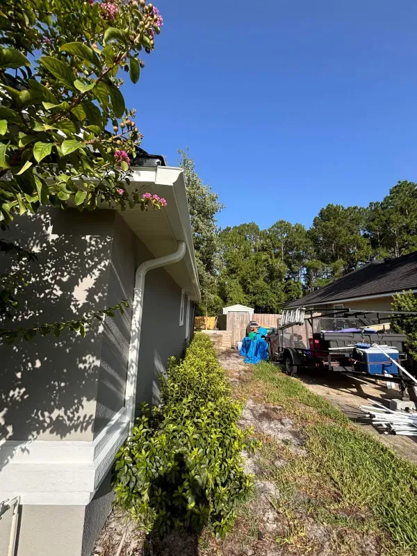 A house with a gutter on the side of it.