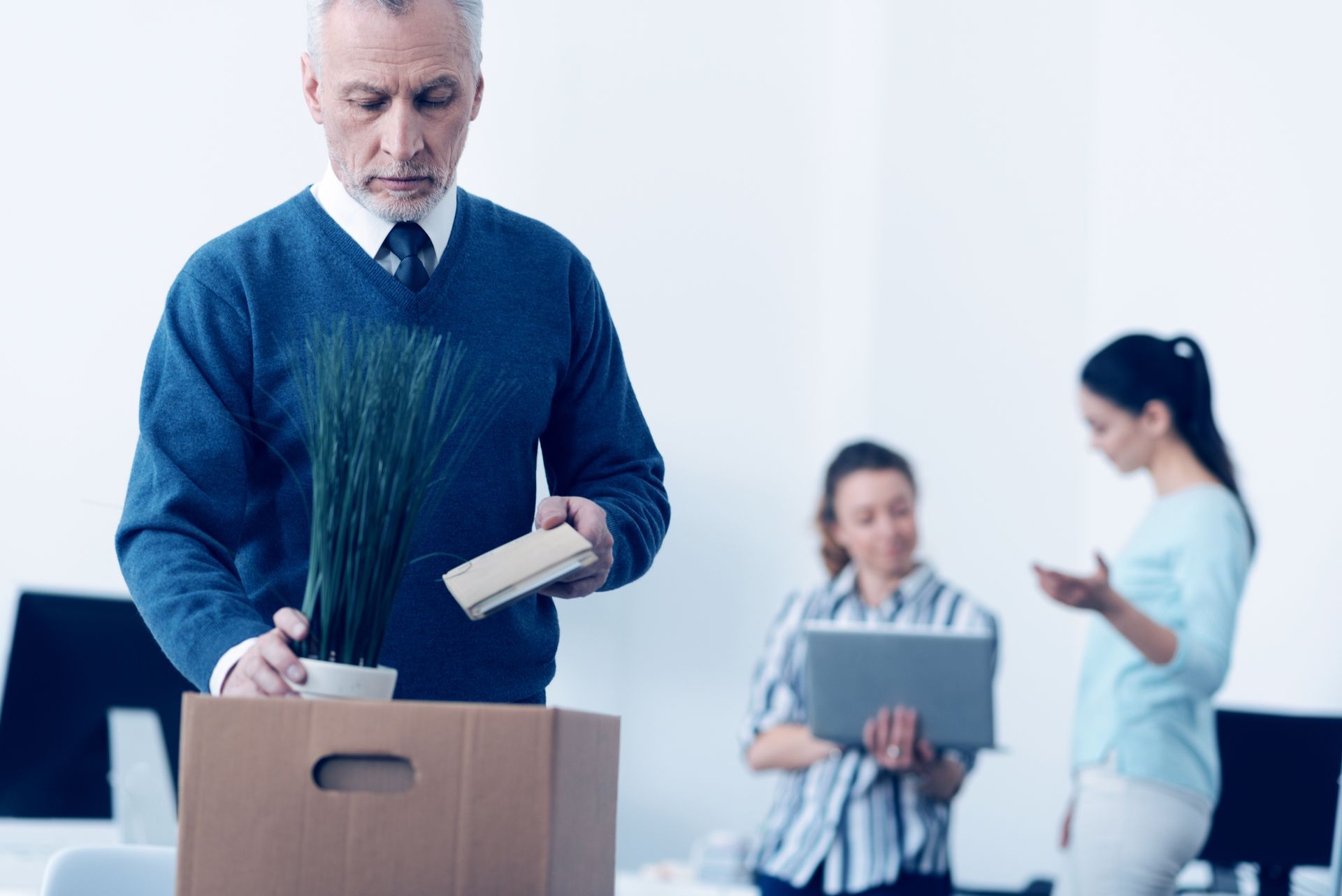 Man packing belongings in box;  wrongful termination or discrimination claims.