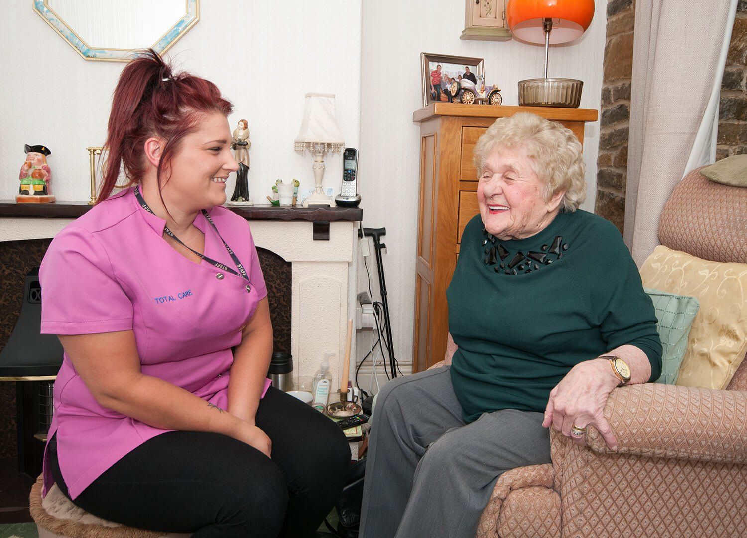 Photo of a carer during work with an elderly woman