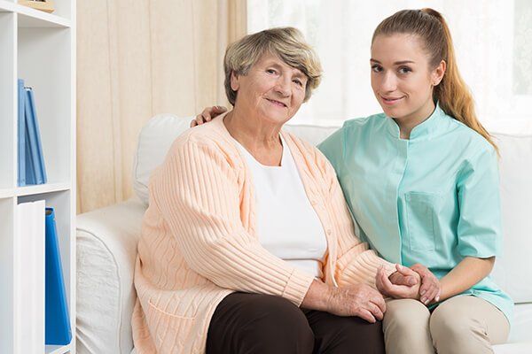 Photo of an elderly woman with a carer