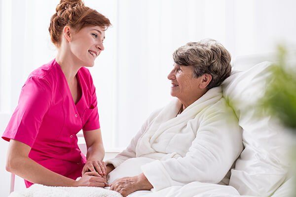 Photo of an elderly woman with a carer