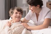 elderly woman being taken care of by a young carer