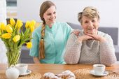 Elderly woman and her carer