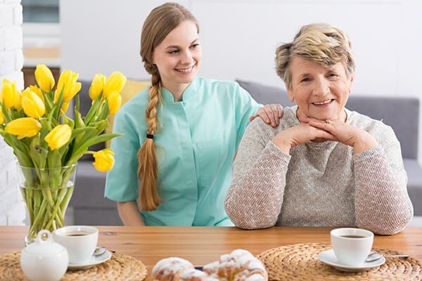Photo of an elderly woman with a carer