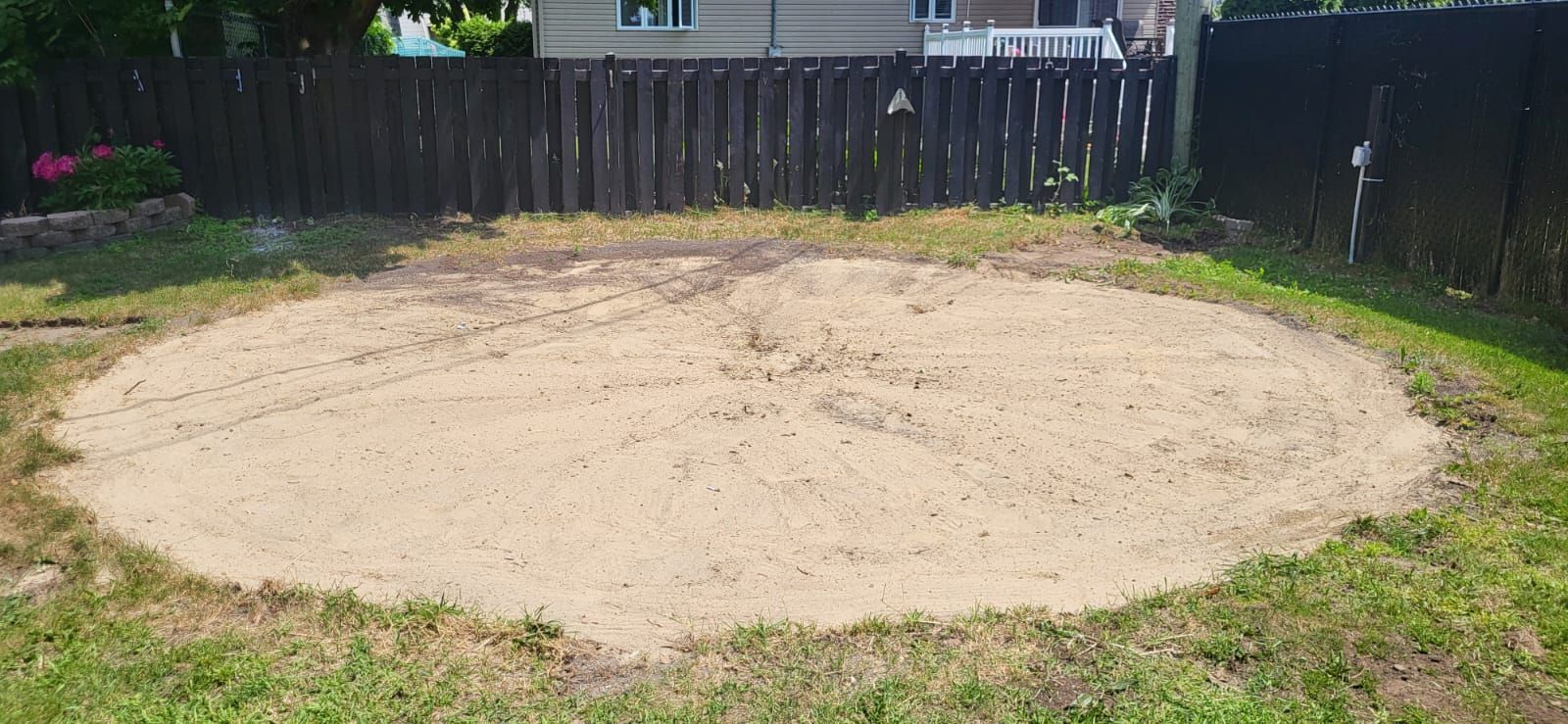 There is a large circle of dirt in the middle of the grass.