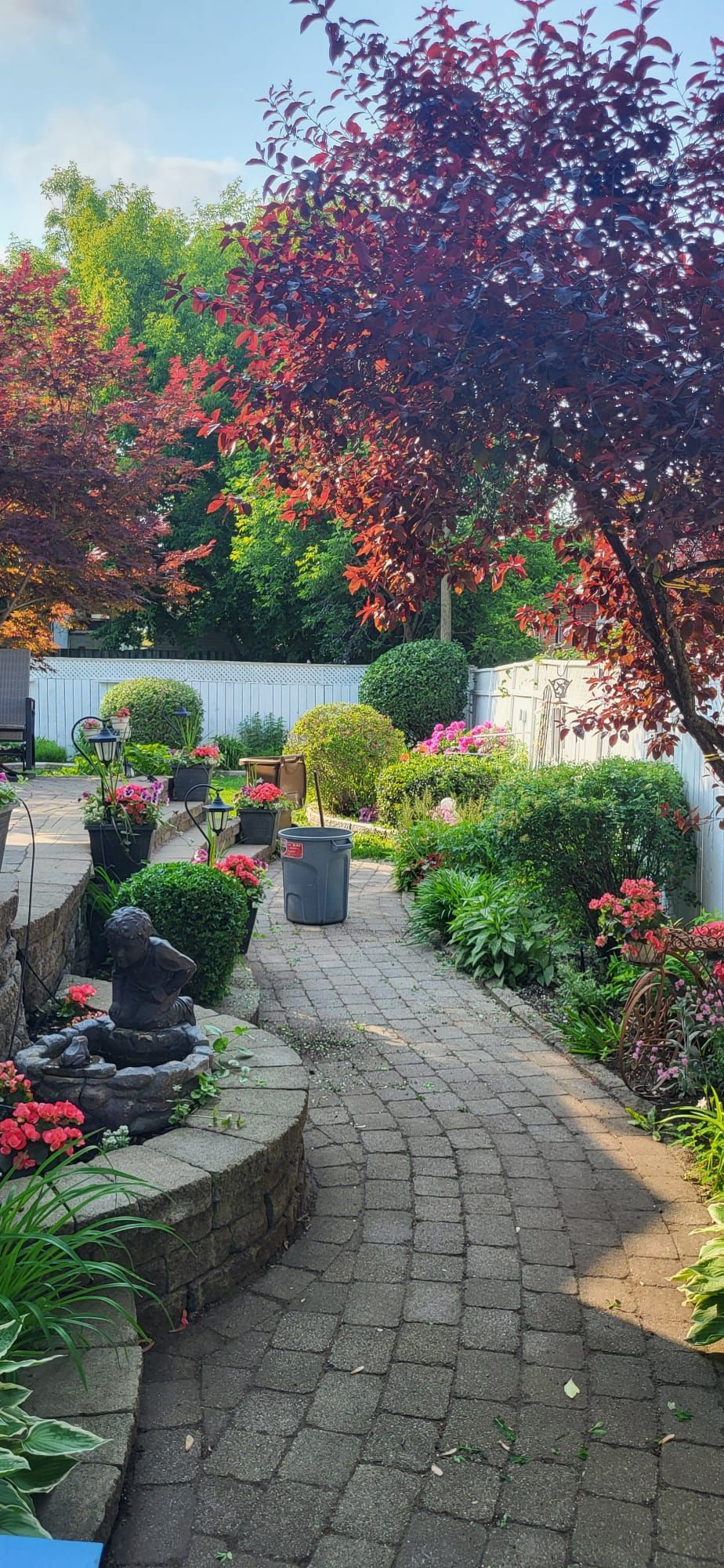 There is a fountain in the middle of the garden.