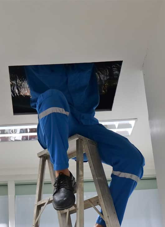 Technician Checking the Ceiling — Zachary, LA — Hughes Mechanical Contractors