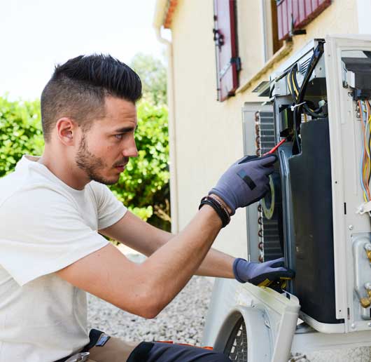 Man Repairs the Air Condition Unit — Zachary, LA — Hughes Mechanical Contractors