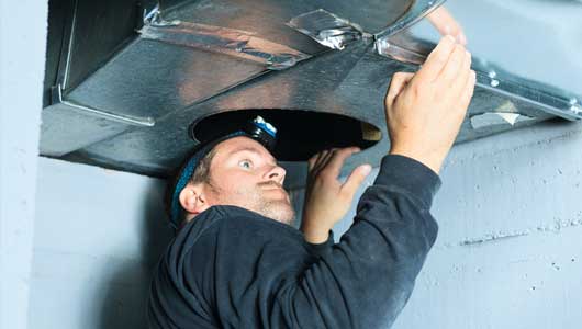 Man Checking the Ventilation — Zachary, LA — Hughes Mechanical Contractors