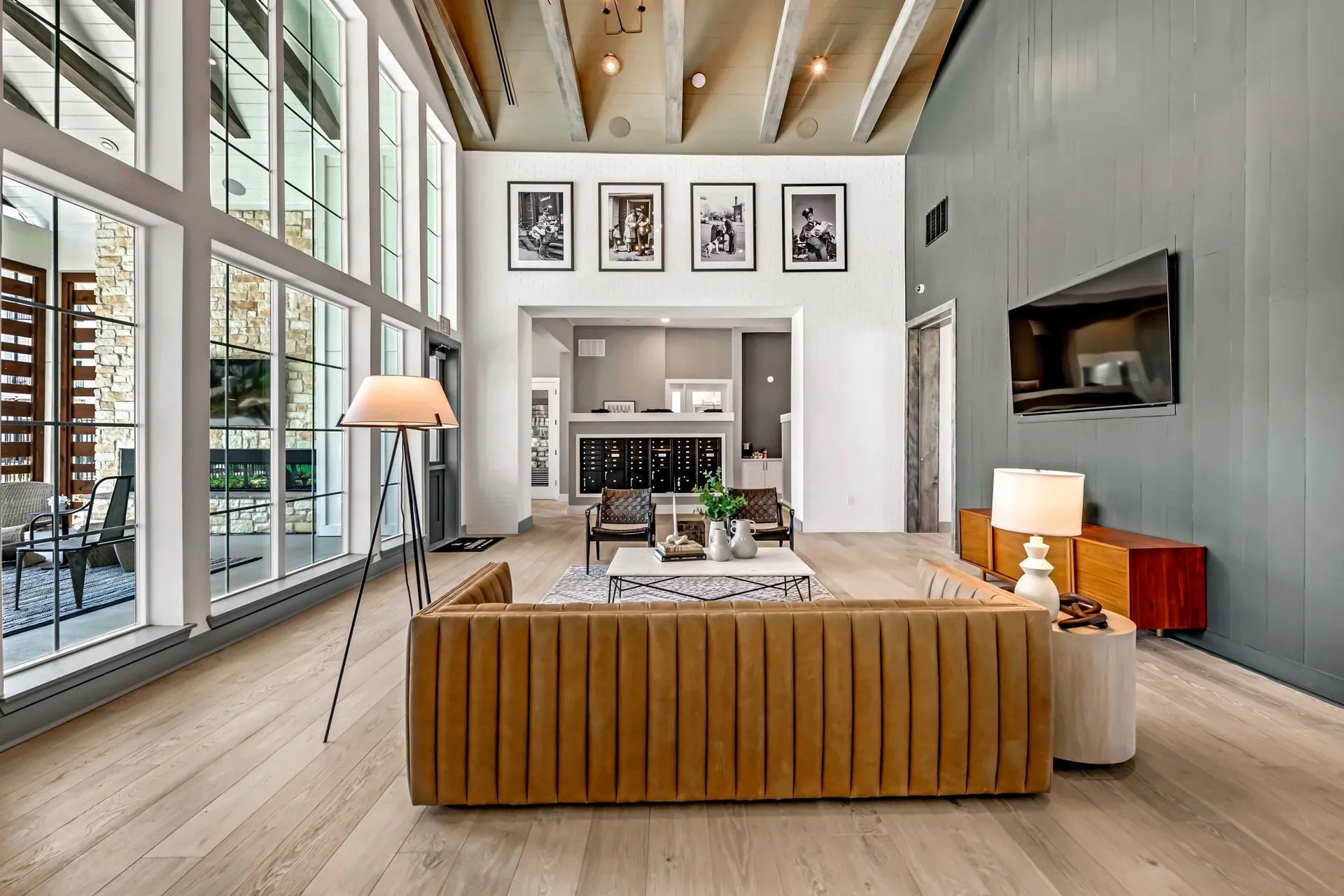 A kitchen with a large island , stools , a refrigerator and a microwave at Atlas Bluewood in Celina, TX.