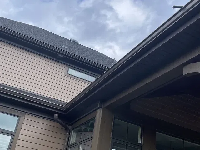 Looking up at the roof of a house with a gutter