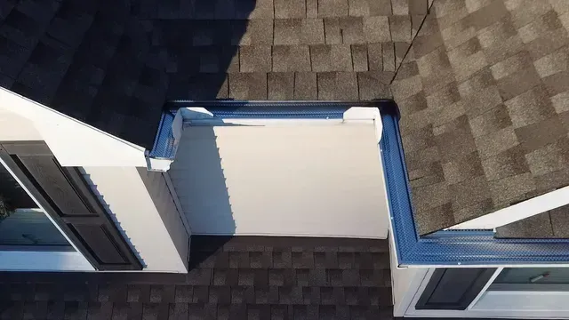 An aerial view of a house with a roof and gutters.