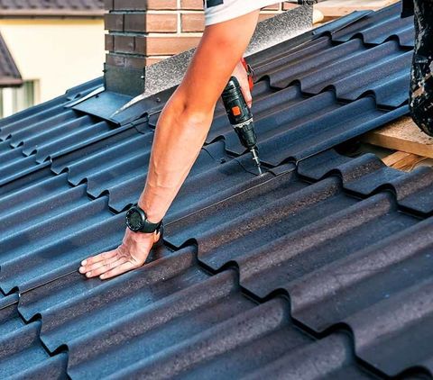 Roofing Companies — Construction Worker Repairing the Roof in Albert Lea, MN