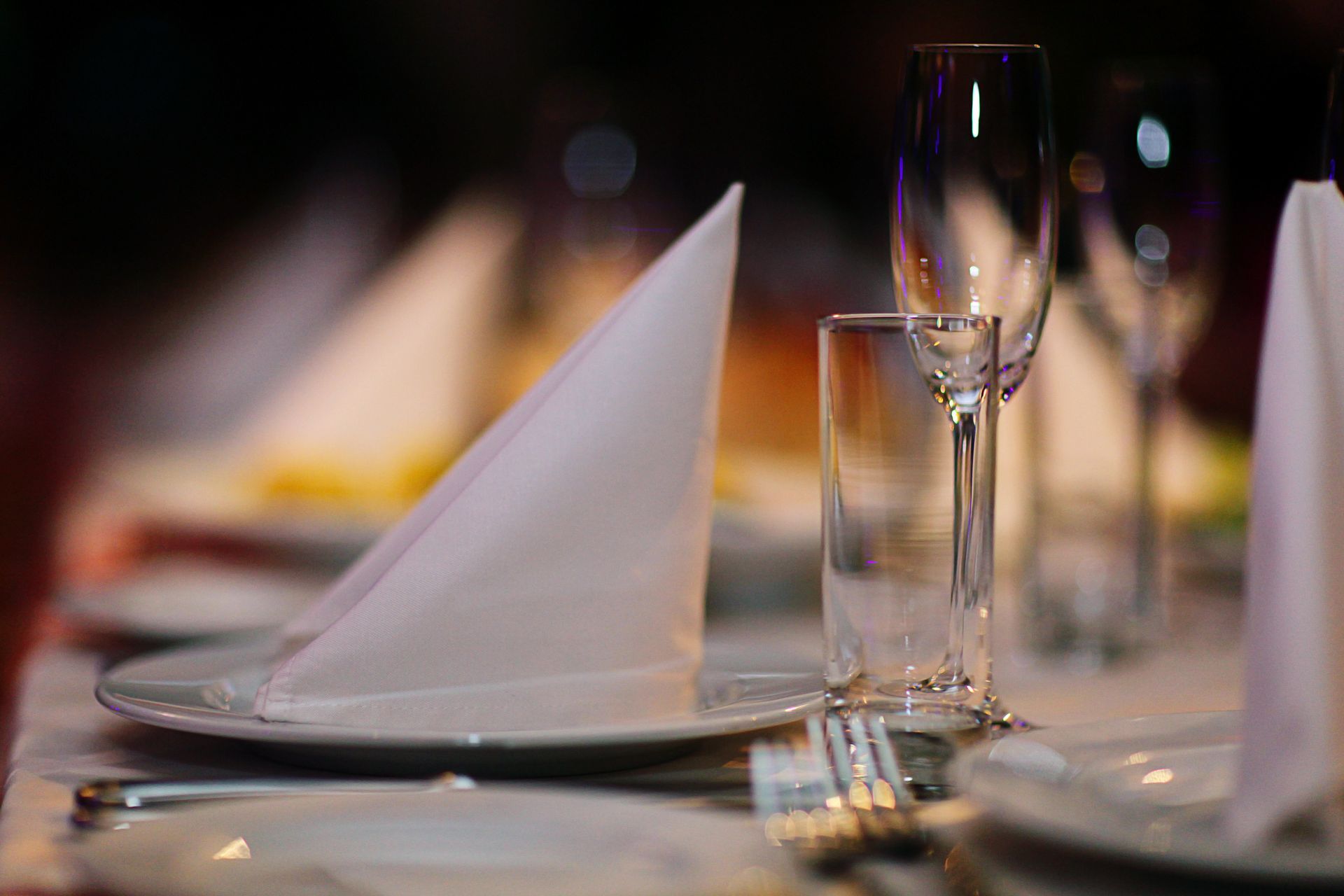 Table setting with folded napkin, glassware, and silverware.