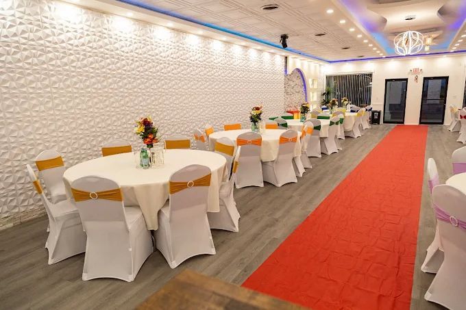 Bride and groom dance on a foggy dance floor at an outdoor wedding reception, with string lights and a floral backdrop.