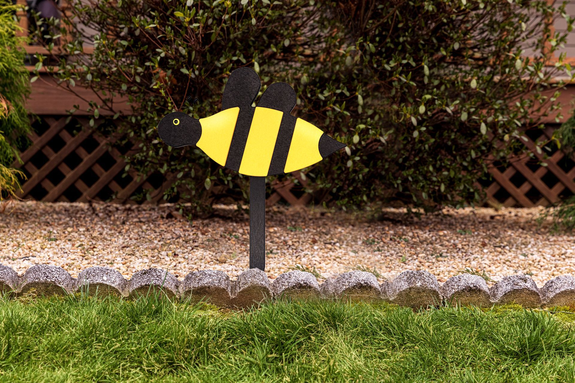 Shelf with gold and black decor: vases, swan figurines, candles, globe, and art against a teal wall.