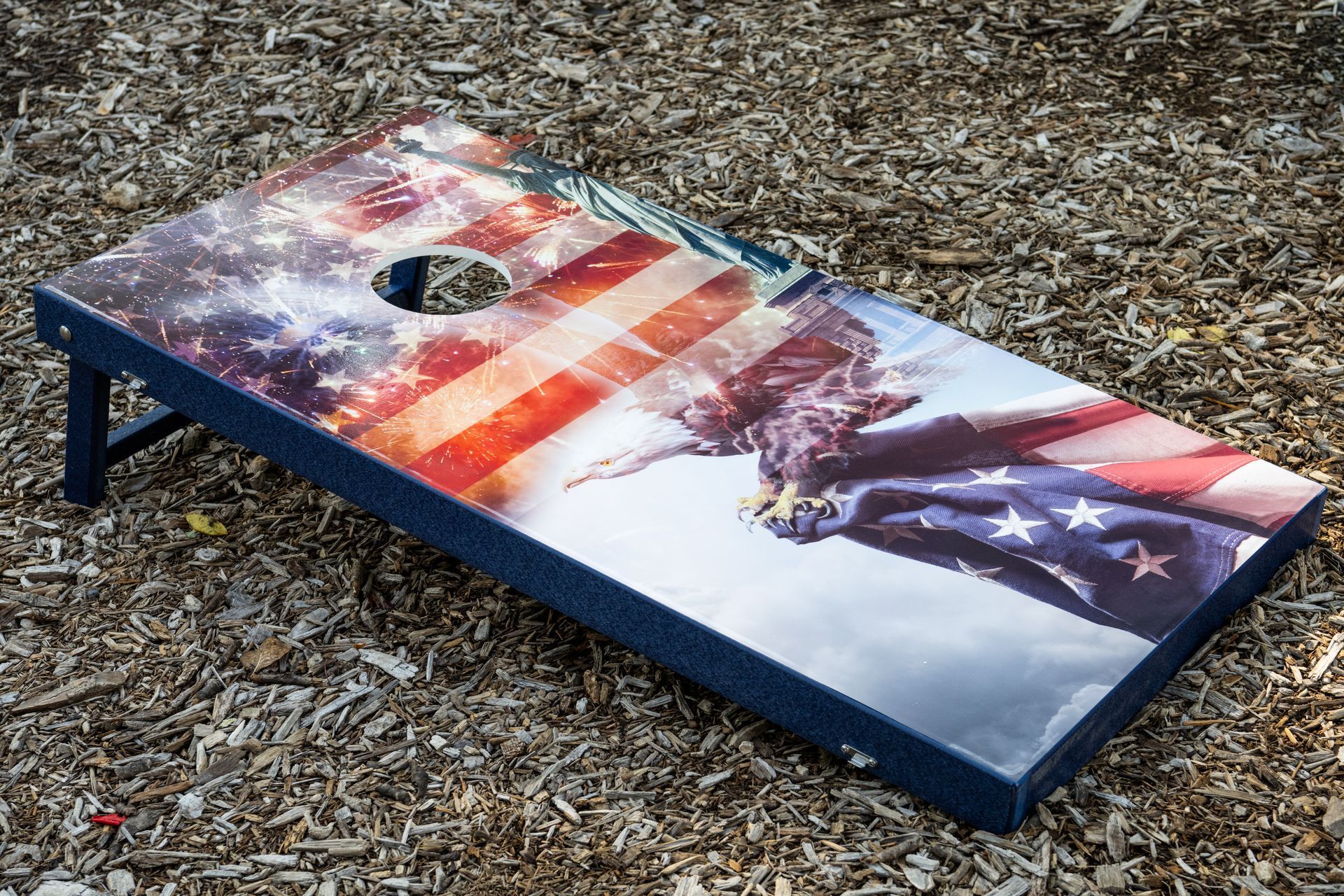 Cornhole board with ocean sunset design, aqua-colored frame, and a hole.