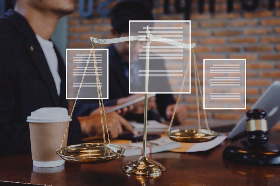 Scales of justice with documents overlaid; lawyer in background, coffee cup, gavel.