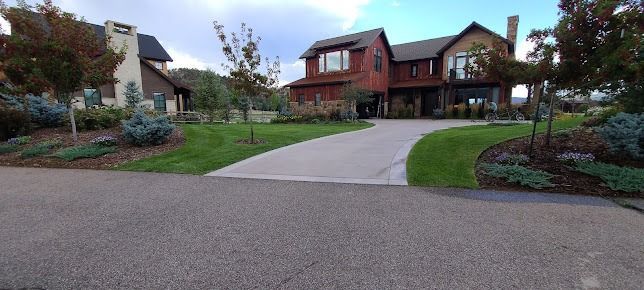 A large house with a long driveway leading to it.