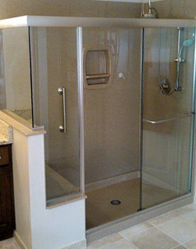 A bathroom with a sliding glass shower door