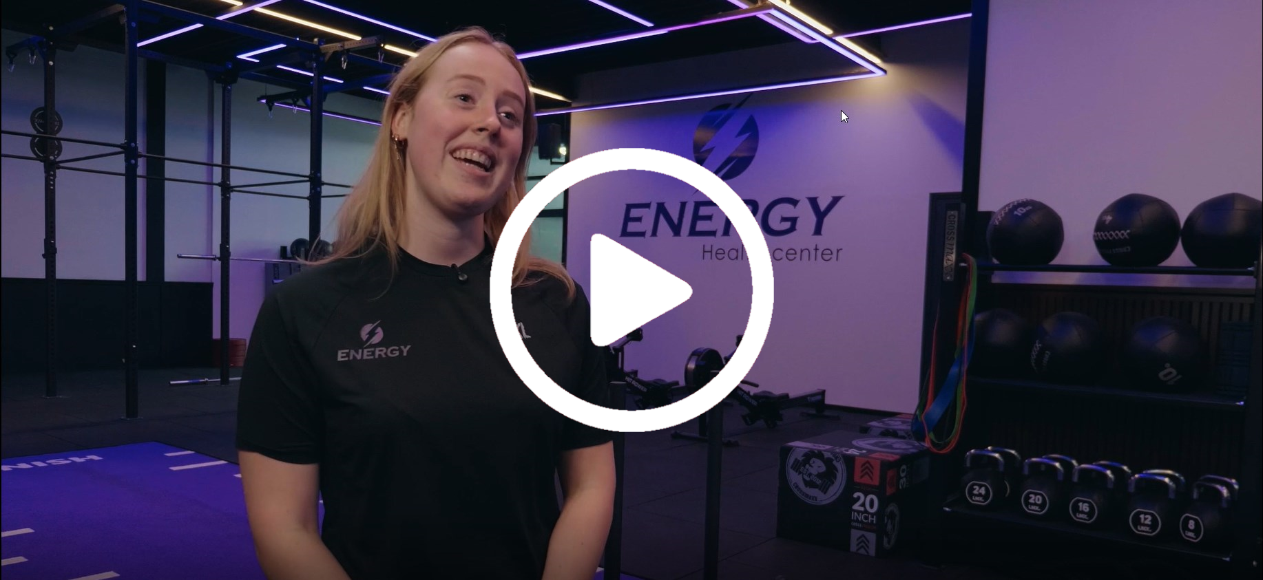 Een man met een underarmour-shirt is in een sportschool