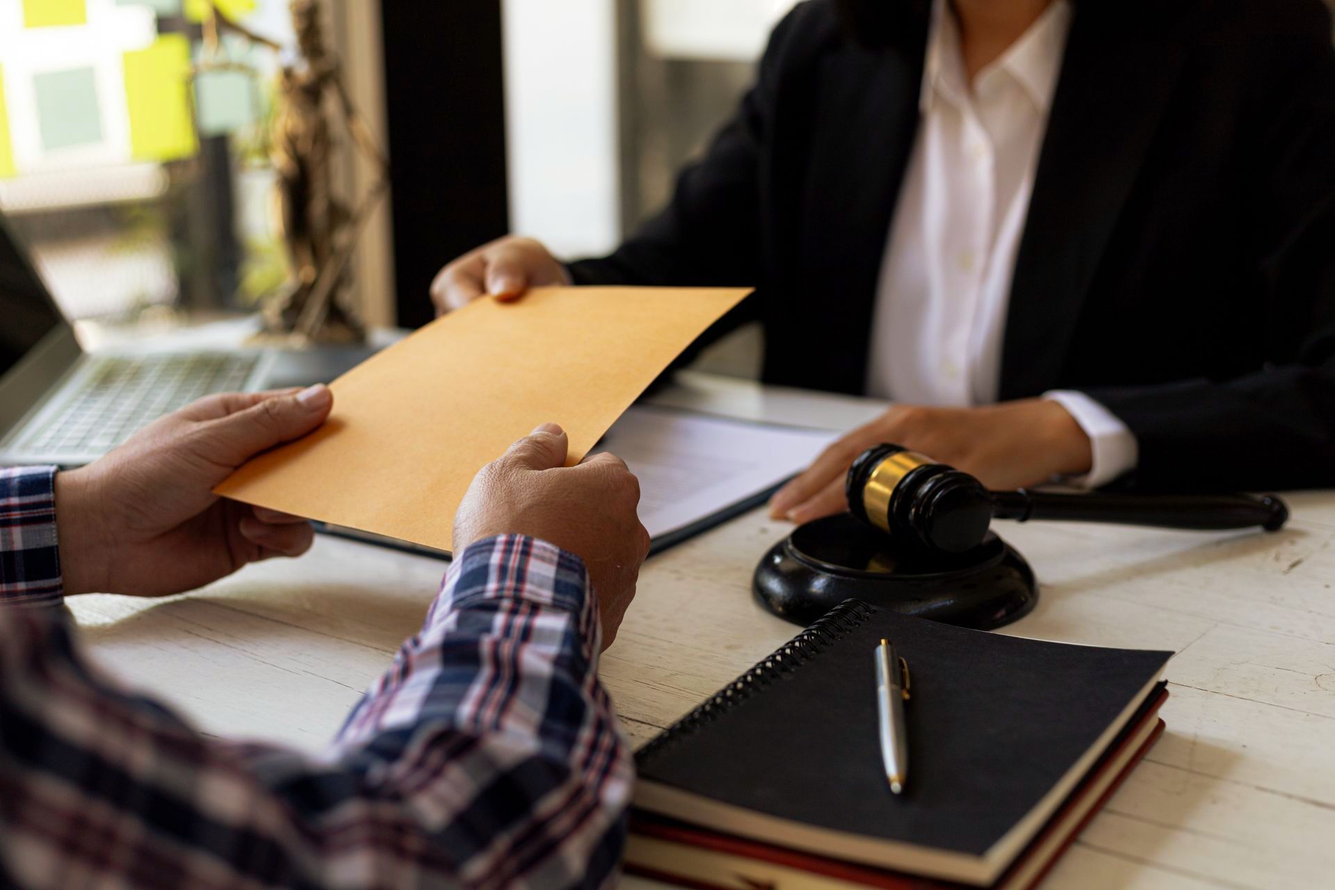 A man is handing an envelope to a judge.