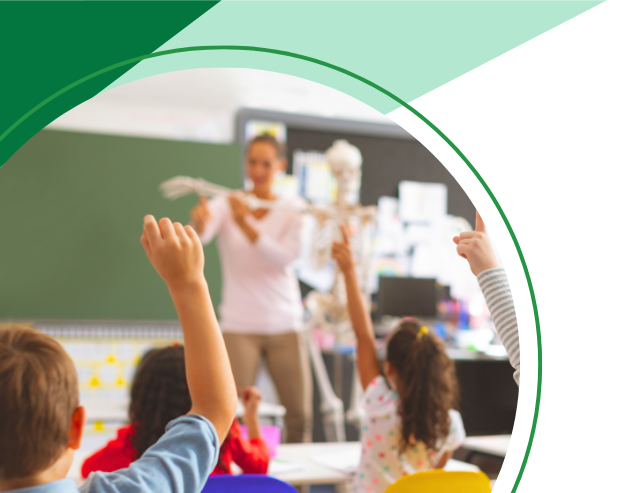 A group of children are raising their hands in a classroom